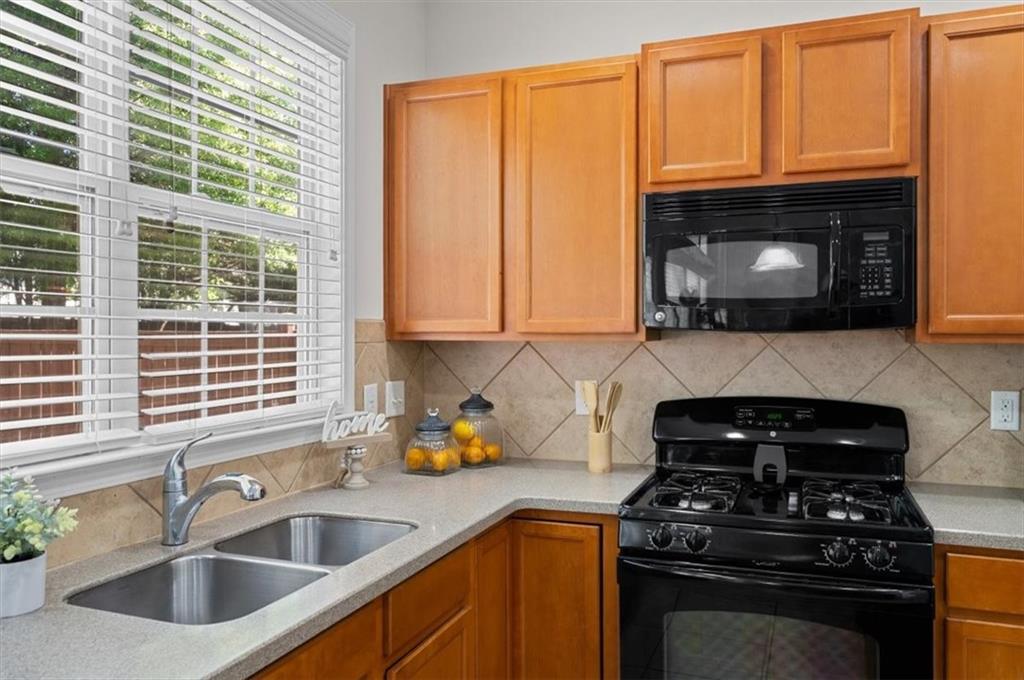 825 Poplar Terrace Canton, GA 30115 - Photo 14 of 46 a kitchen with granite countertop a sink stainless steel appliances and cabinets
