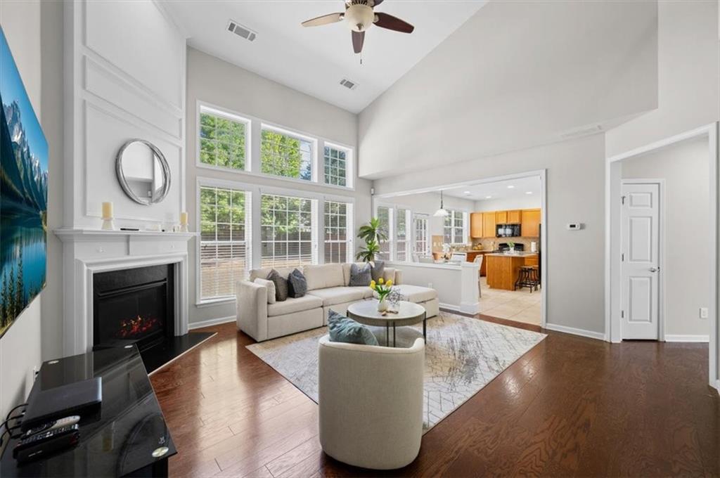 825 Poplar Terrace Canton, GA 30115 - Photo 17 of 46 a living room with furniture a fireplace and a floor to ceiling window