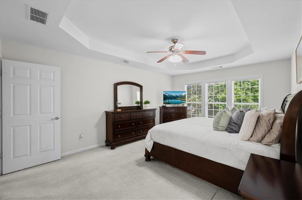 825 Poplar Terrace Canton, GA 30115 - Photo 23 of 46 a bedroom with a large bed and a chandelier