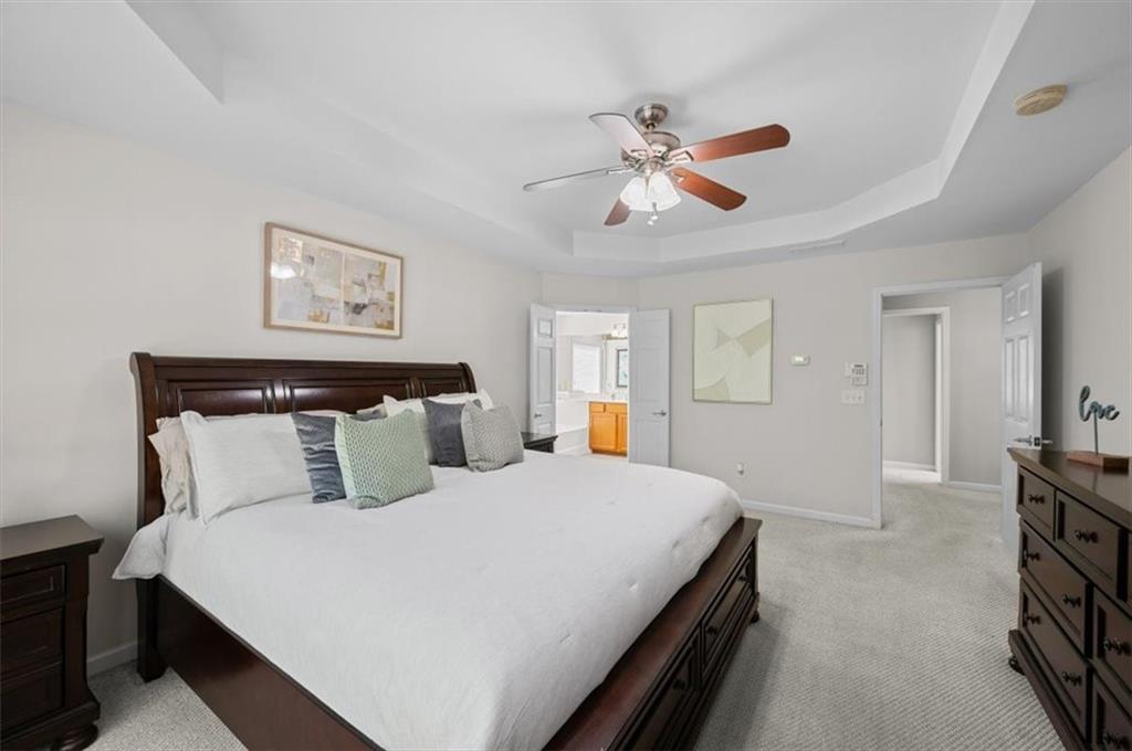 825 Poplar Terrace Canton, GA 30115 - Photo 24 of 46 a bedroom with a large bed and a chandelier