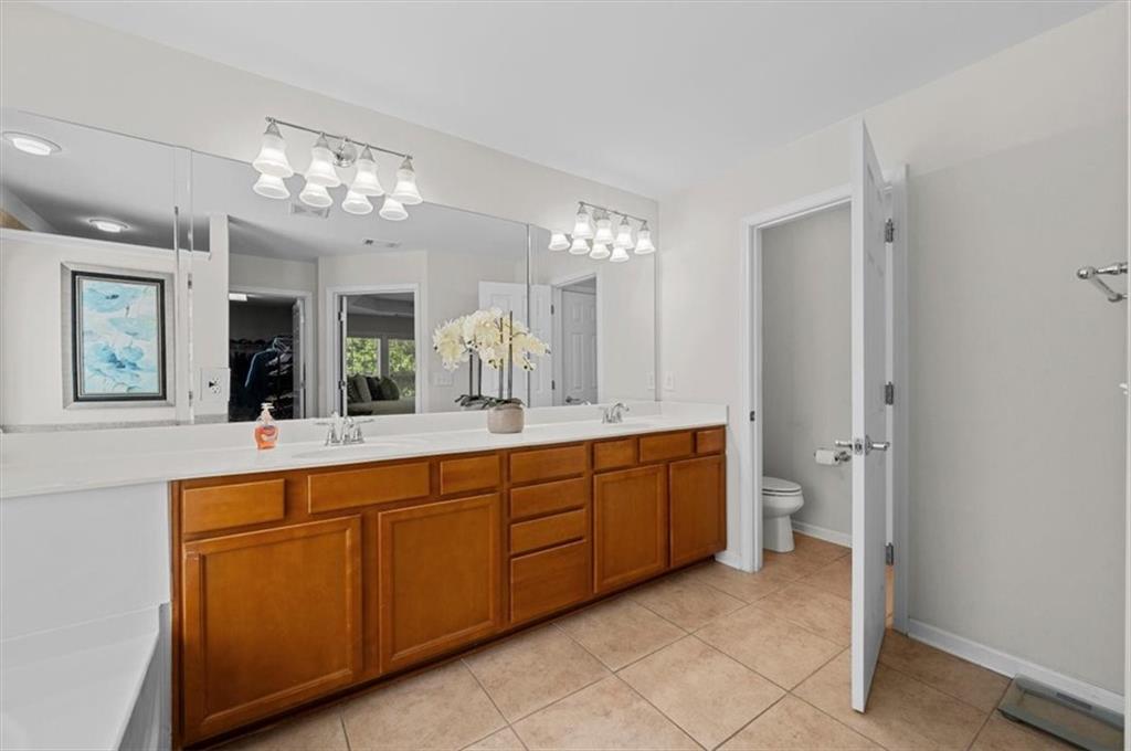 825 Poplar Terrace Canton, GA 30115 - Photo 26 of 46 a spacious bathroom with double vanity and a mirror