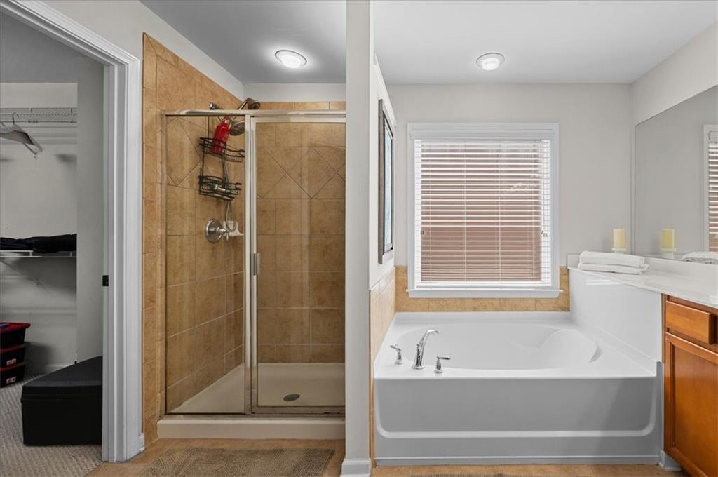 825 Poplar Terrace Canton, GA 30115 - Photo 27 of 46 a bathroom with a bathtub and a shower