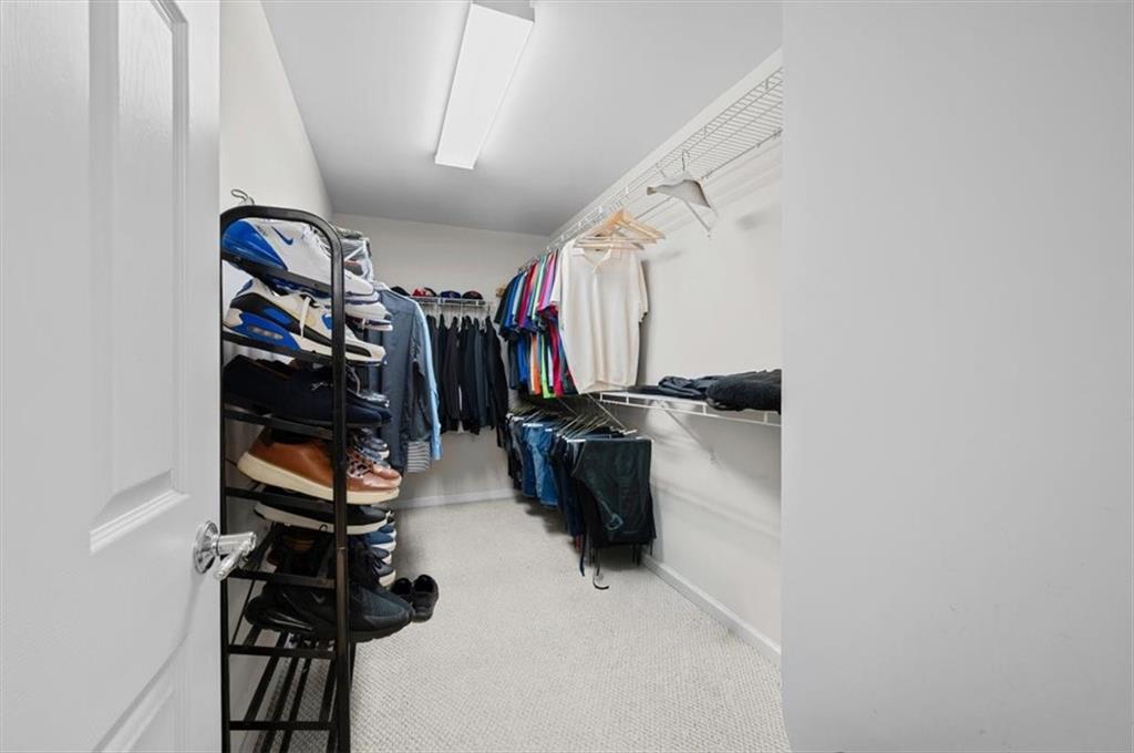 825 Poplar Terrace Canton, GA 30115 - Photo 28 of 46 a view of walk in closet with clothes and shoes