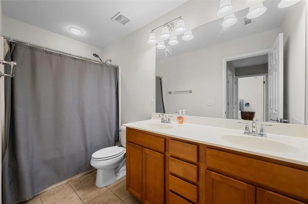 825 Poplar Terrace Canton, GA 30115 - Photo 31 of 46 a bathroom with a sink toilet double vanity and shower