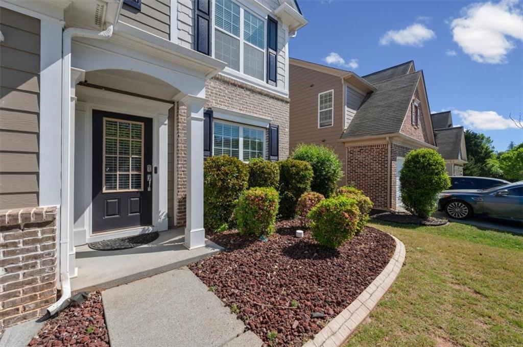 825 Poplar Terrace Canton, GA 30115 - Photo 4 of 46 a view of a house with a yard and a patio