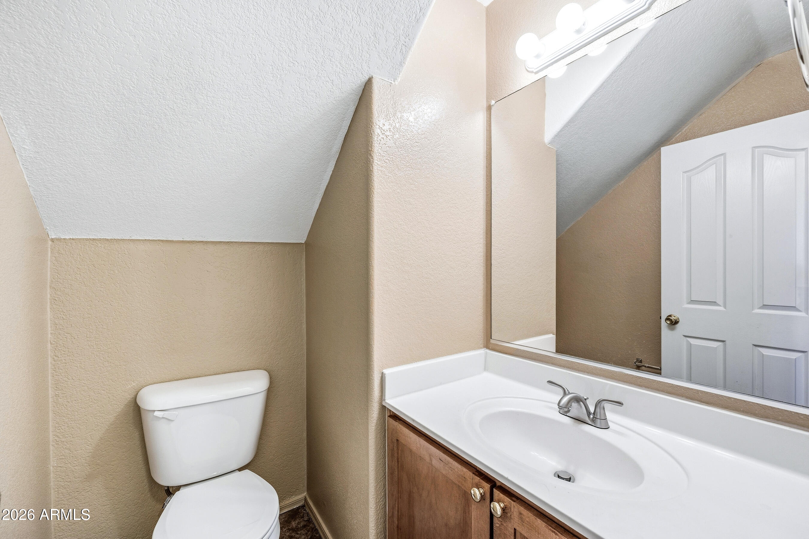 9515 West Monte Vista Road Phoenix, AZ 85037 - Photo 13 of 29 a bathroom with a sink a toilet a mirror and shower