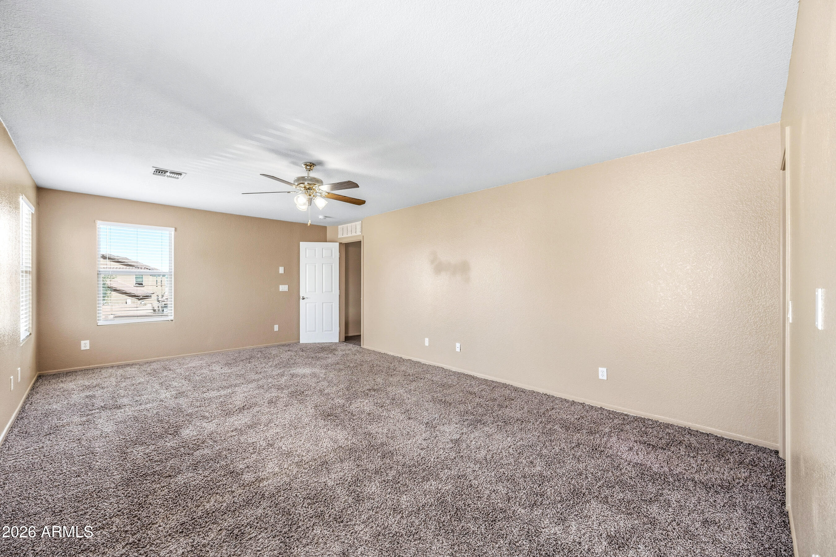 9515 West Monte Vista Road Phoenix, AZ 85037 - Photo 17 of 29 a view of a big room with windows and chandelier fan