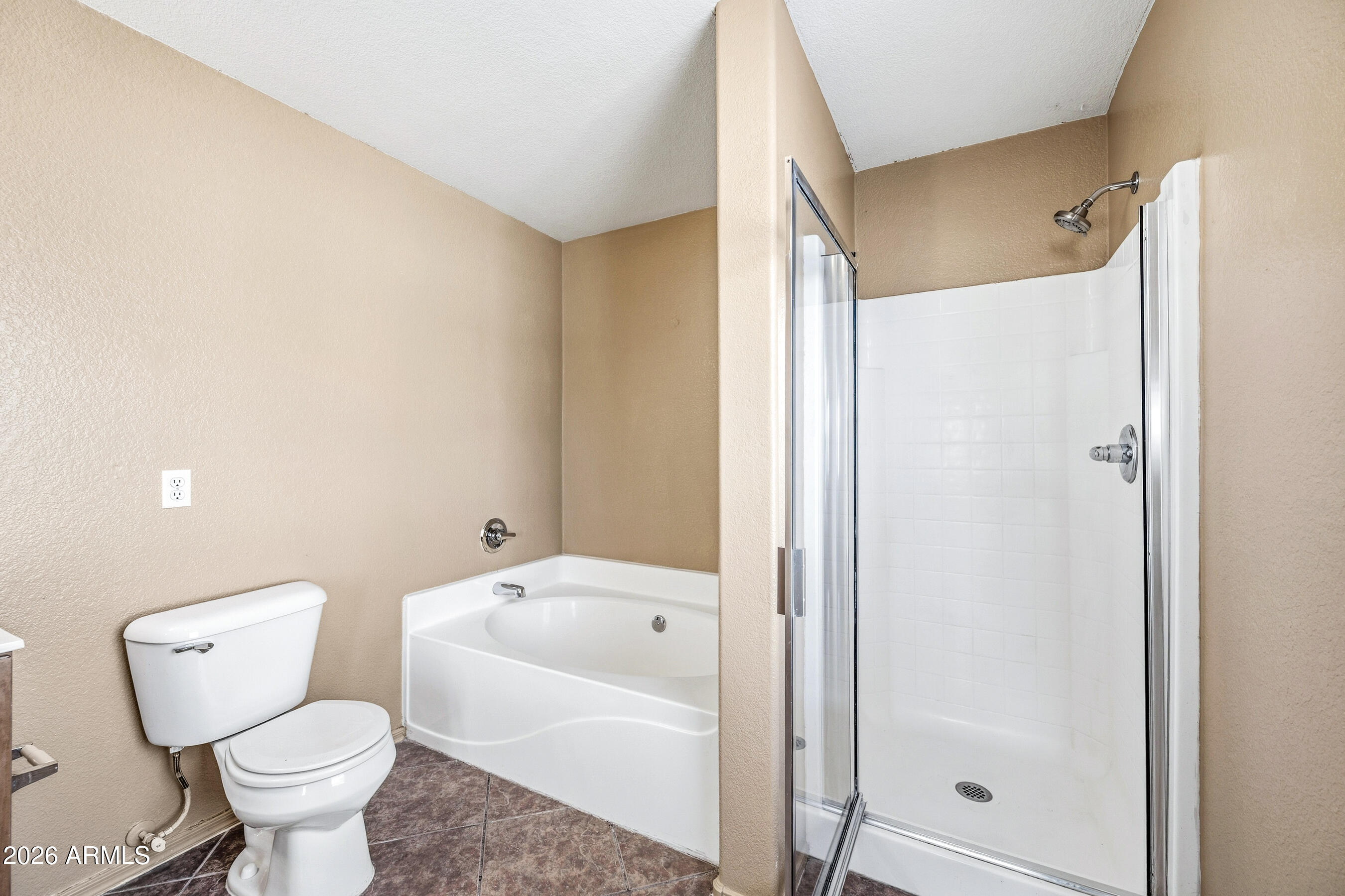 9515 West Monte Vista Road Phoenix, AZ 85037 - Photo 19 of 29 a bathroom with a toilet and a shower