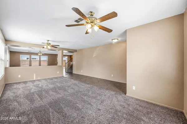 a view of a livingroom with a ceiling fan and window