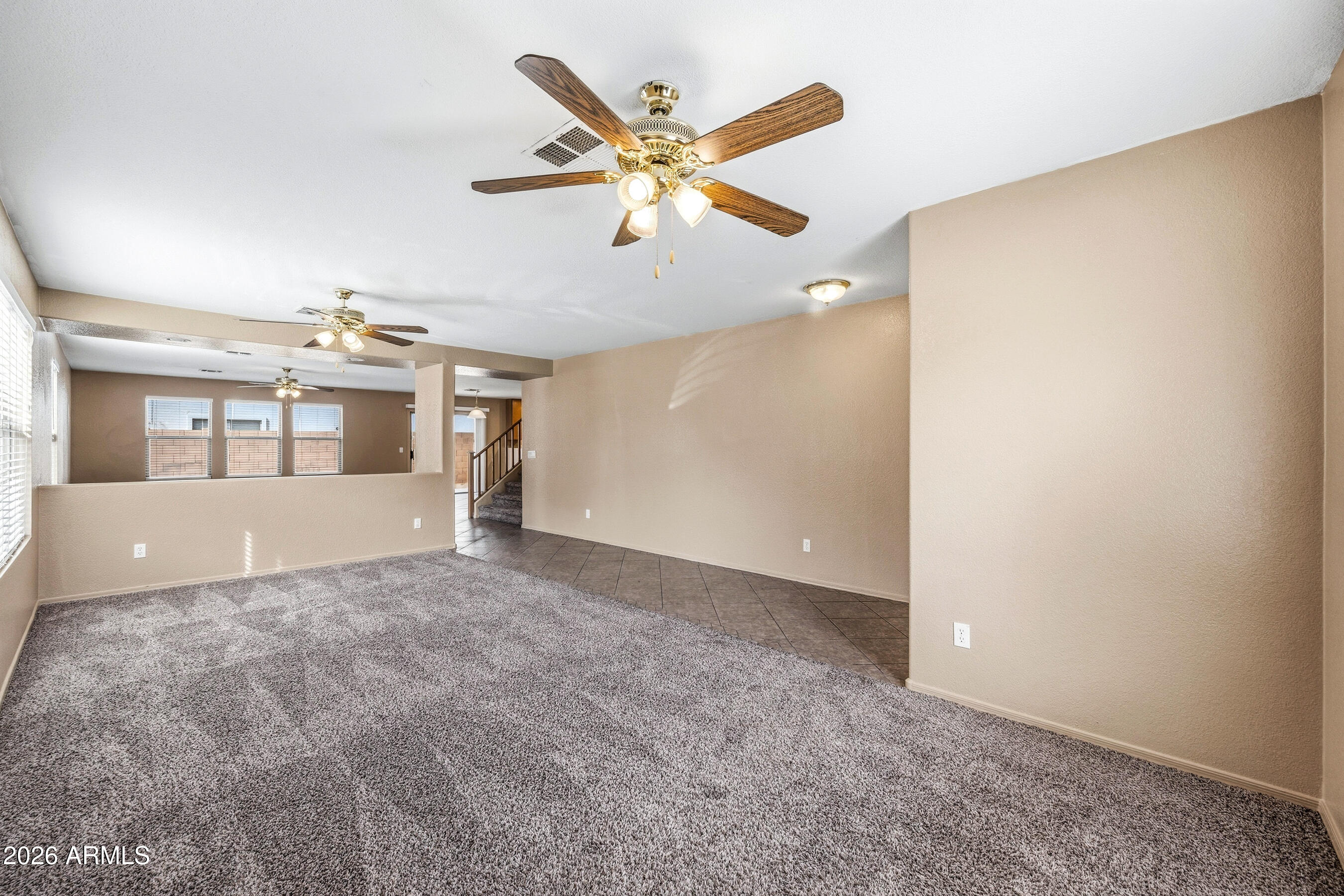 9515 West Monte Vista Road Phoenix, AZ 85037 - Photo 4 of 29 a view of a livingroom with a ceiling fan and window