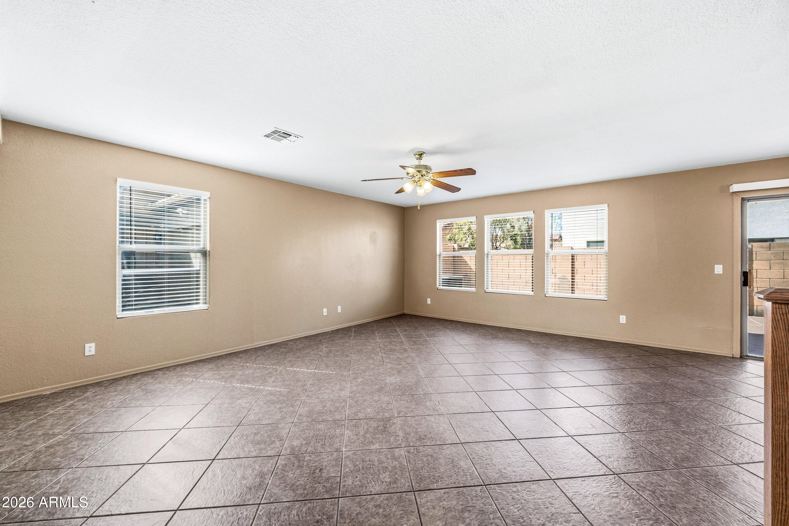 9515 West Monte Vista Road Phoenix, AZ 85037 - Photo 5 of 29 a view of an empty room with a window