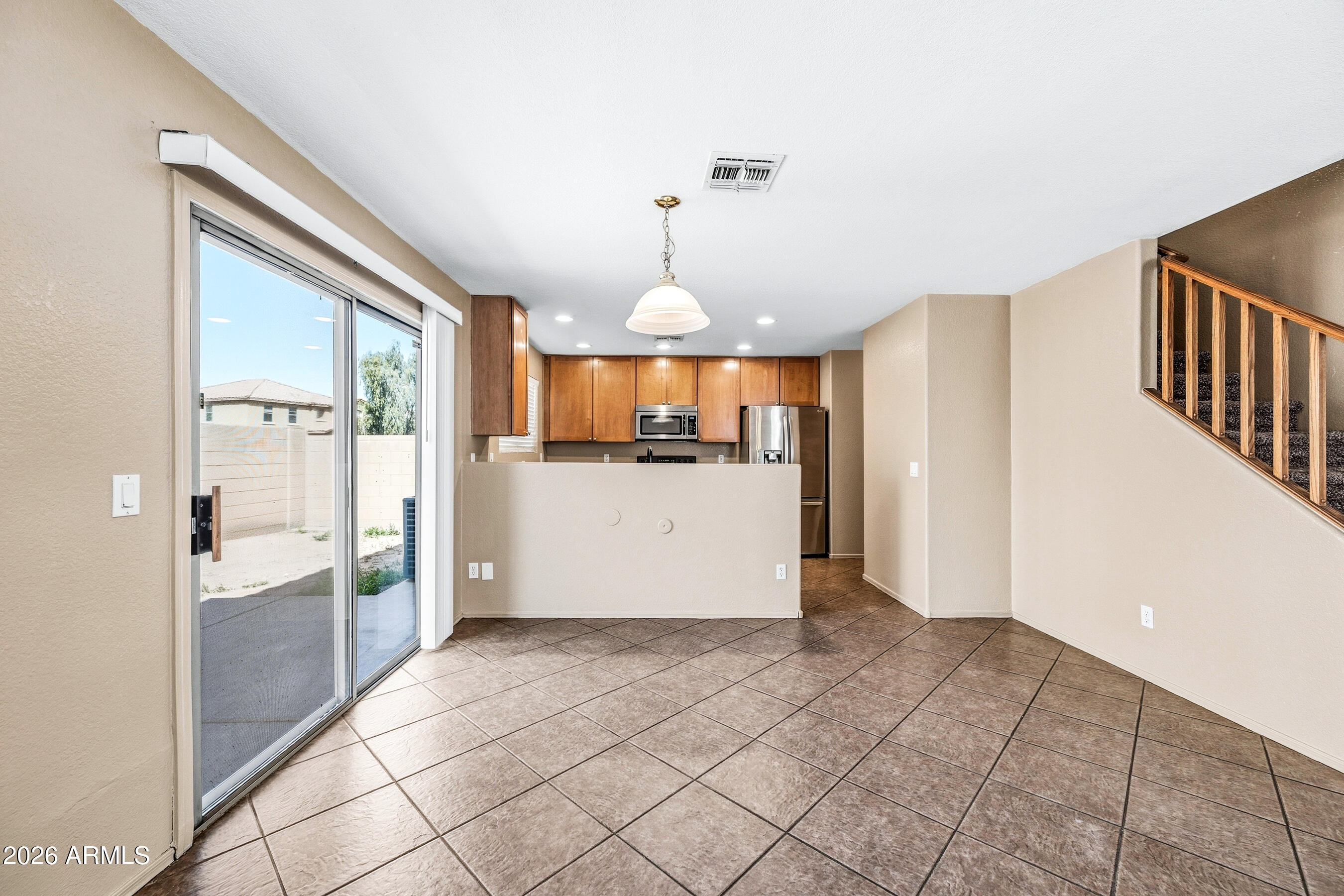9515 West Monte Vista Road Phoenix, AZ 85037 - Photo 8 of 29 a view of a kitchen with a refrigerator and a sink