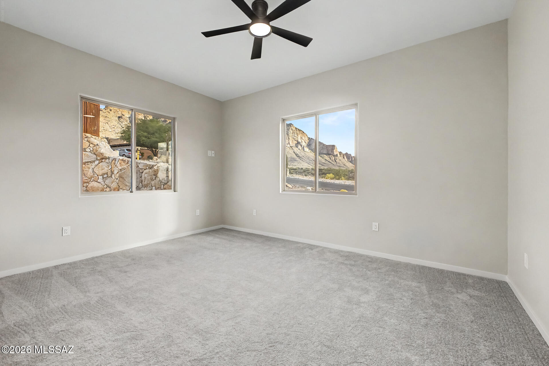 2399 Della Roccia Court Tucson, AZ 85737 - Photo 25 of 34 an empty room with a window and a ceiling fan