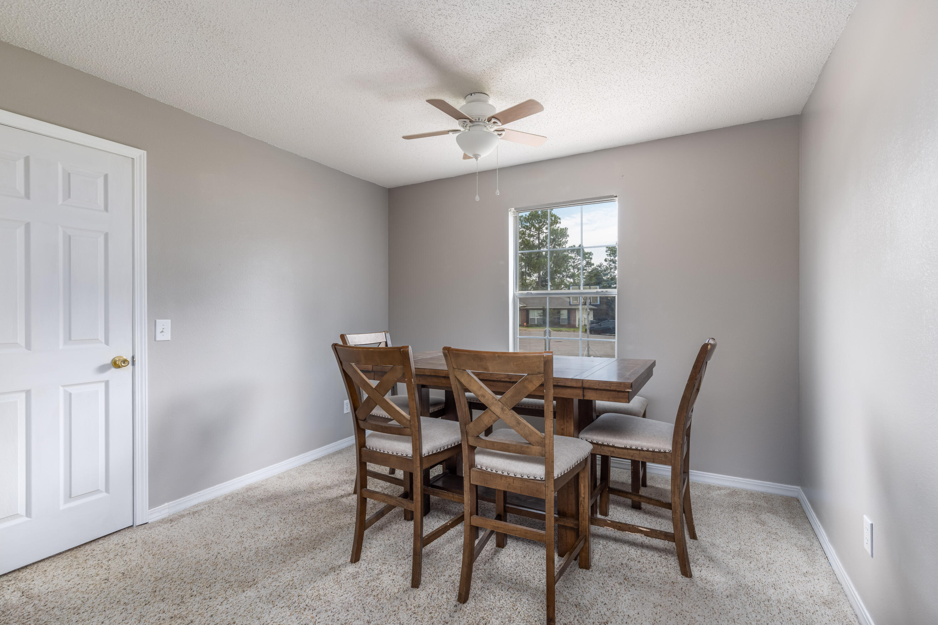 144 Sandstone Trail Crestview, FL 32539 - Photo 8 of 22 a view of a dining room with furniture and a window