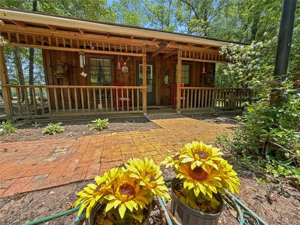 a view of a house with a small yard and wooden fence