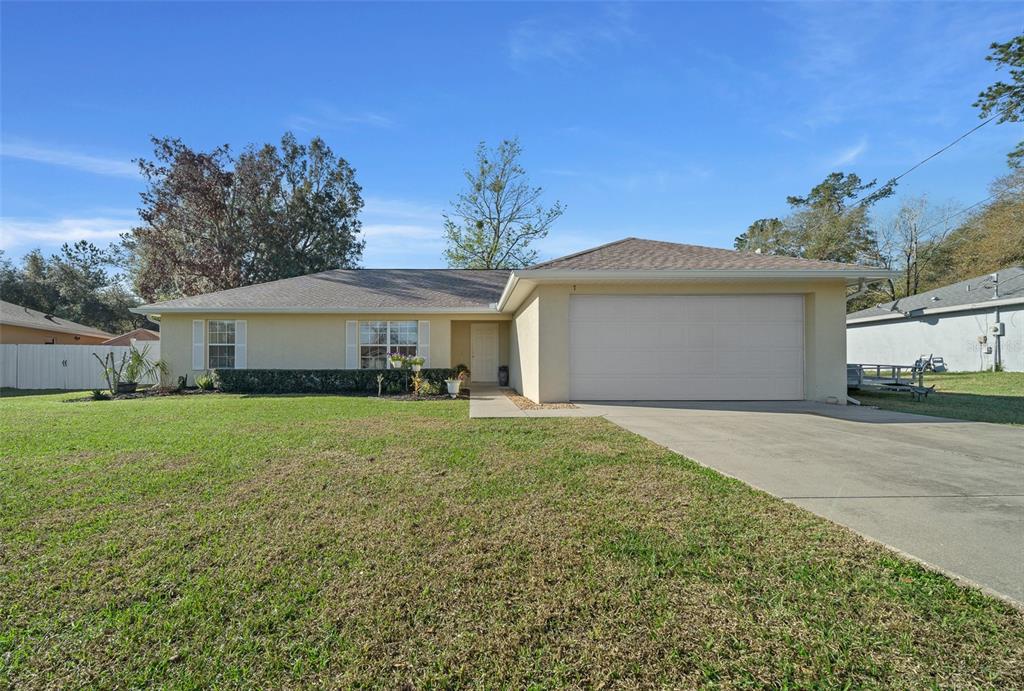 a front view of a house with a garden and yard