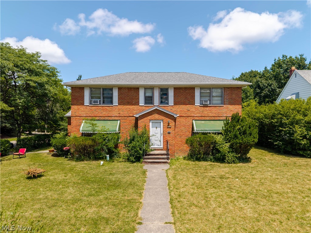 3825 Mayfield Road Cleveland Heights, OH 44121 - Photo 1 of 27 Brick façade residence with a central entry, a gray shingle roof, and established landscaping