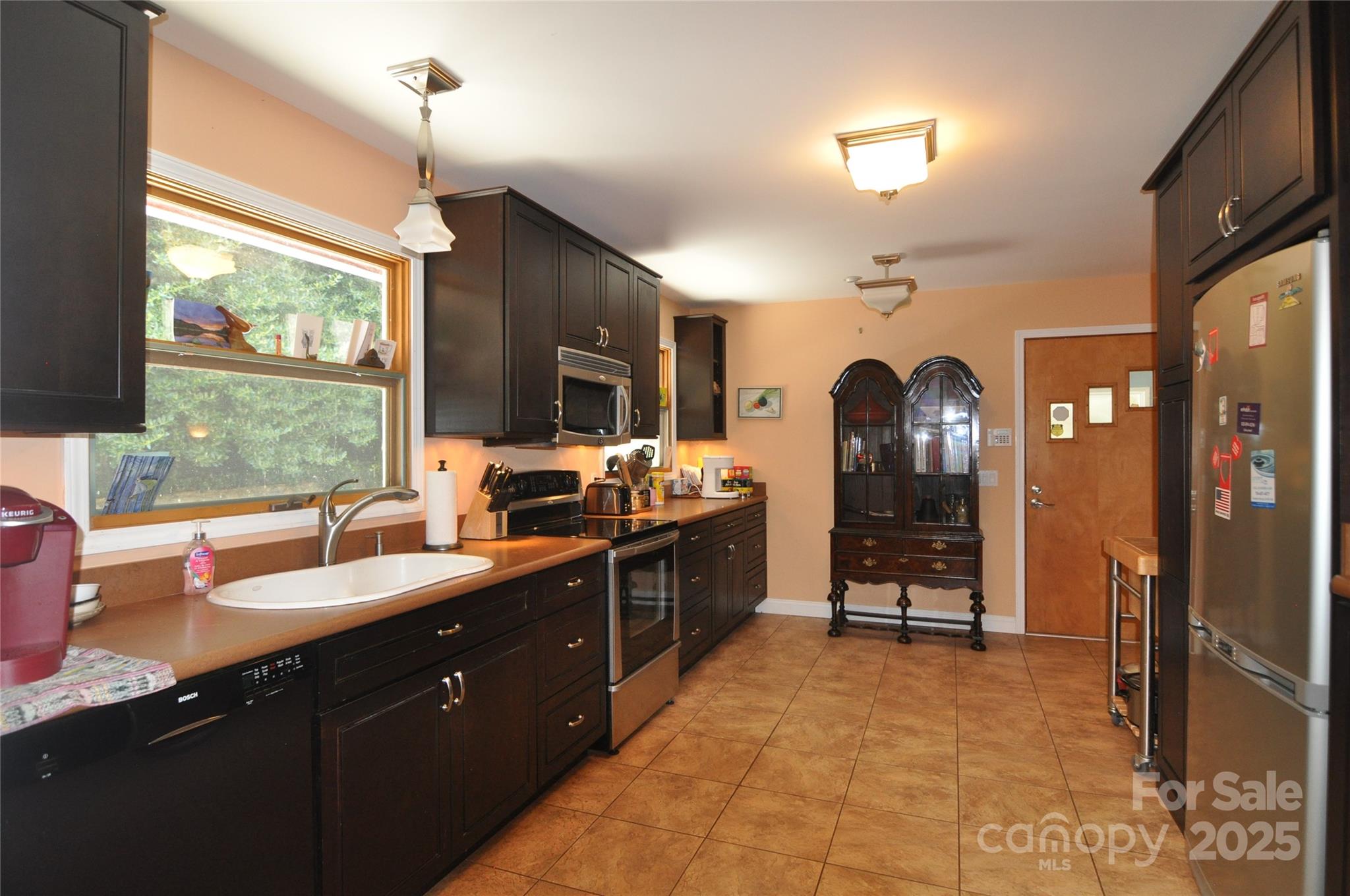 502 Meadowlark Drive Tryon, NC 28782 - Photo 20 of 40 a large kitchen with kitchen island granite countertop a large window and stainless steel appliances
