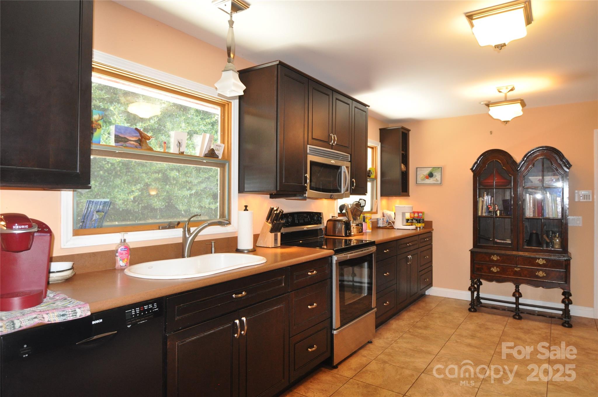 502 Meadowlark Drive Tryon, NC 28782 - Photo 22 of 40 a kitchen with a sink stove and cabinets