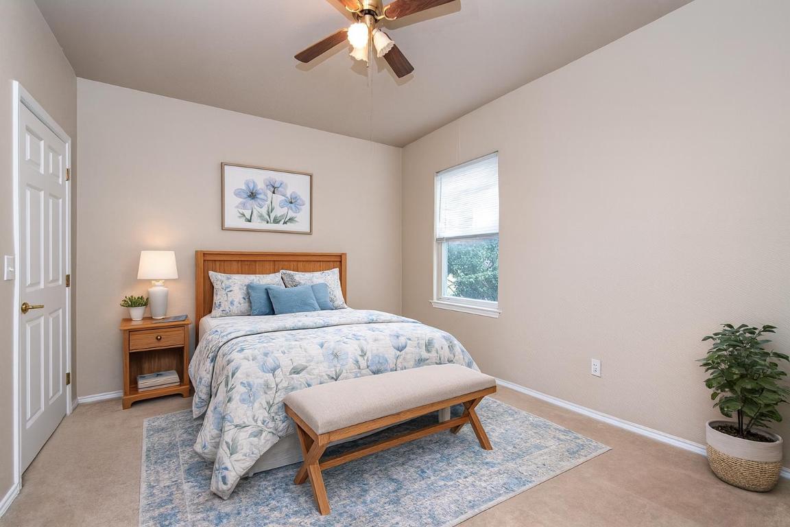 510 Crockett Loop Georgetown, TX 78633 - Photo 11 of 16 a bedroom with a bed and a potted plant
