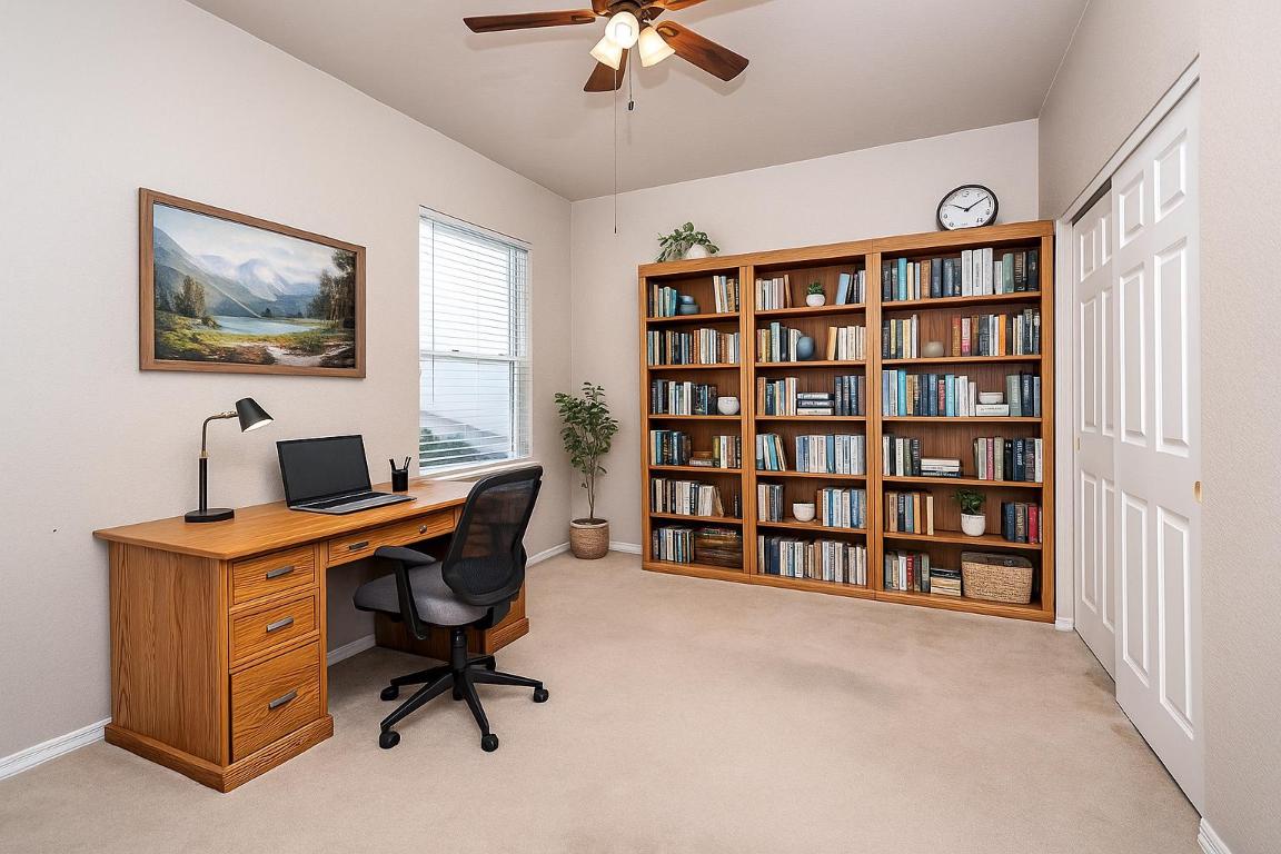 510 Crockett Loop Georgetown, TX 78633 - Photo 12 of 16 a view of a workspace with furniture and a bookshelf