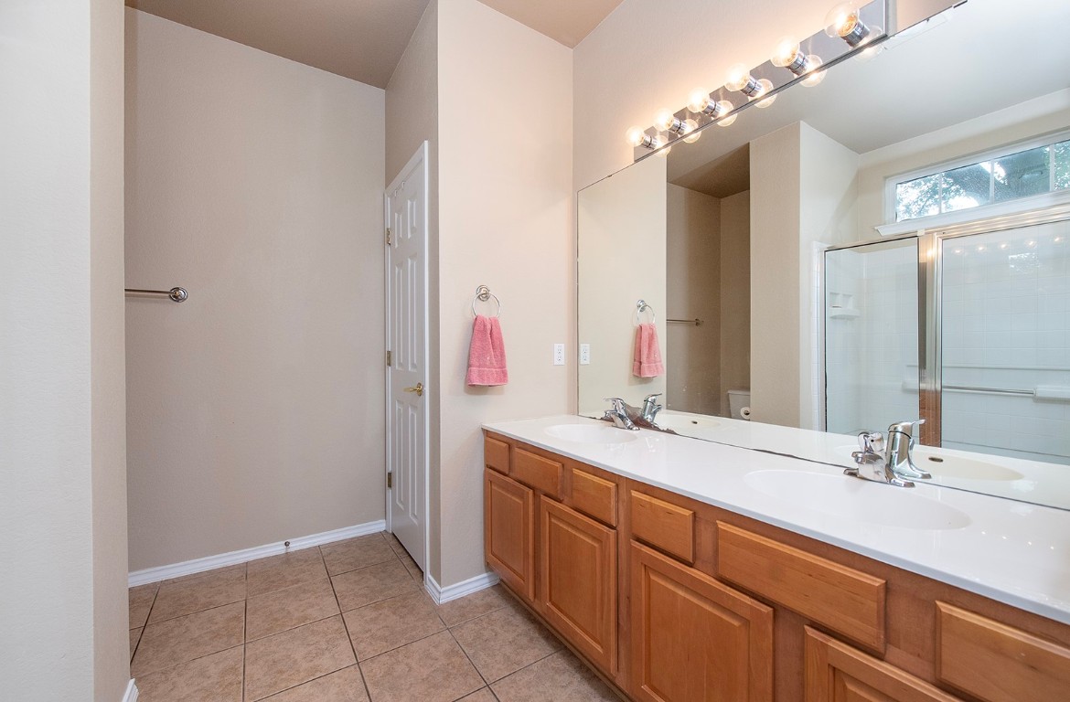 510 Crockett Loop Georgetown, TX 78633 - Photo 9 of 16 a spacious bathroom with a double vanity sink and a mirror