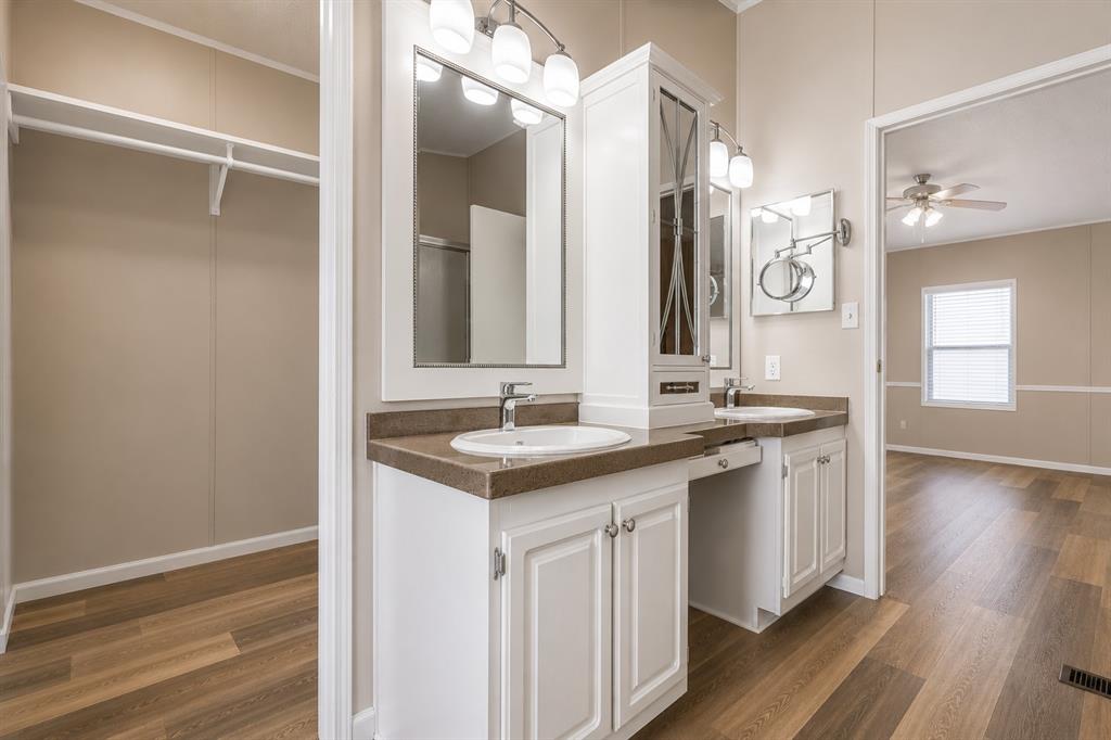9455 Tranquil Acres Road Fort Worth, TX 76179 - Photo 18 of 20 Dual vanity with white cabinetry, brown countertops, and undermount sinks