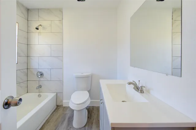 a bathroom with a sink a toilet and bathtub