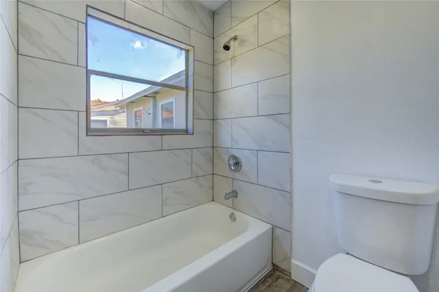 a bathroom with a bathtub and toilet