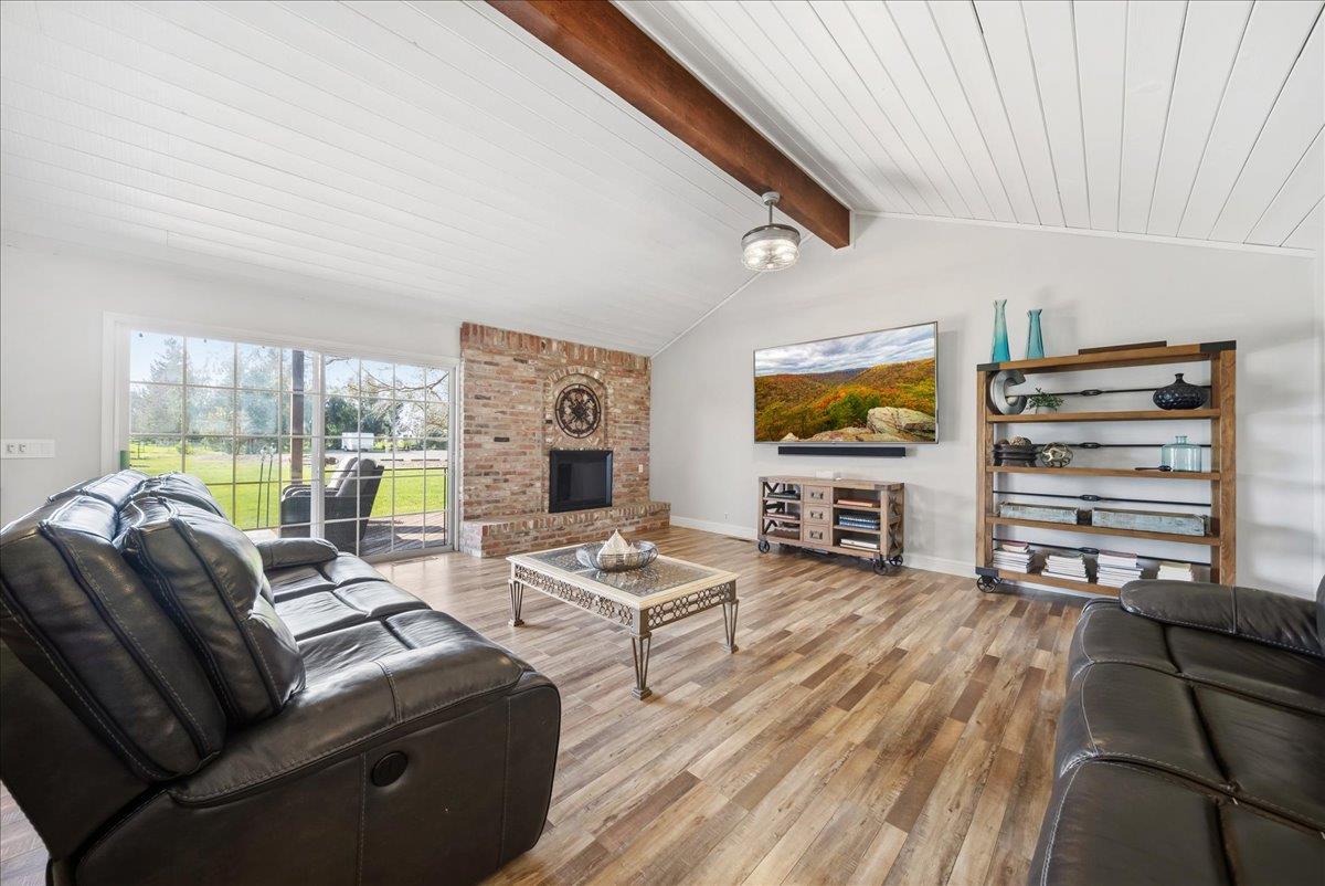 9777 Tavernor Road Wilton, CA 95693 - Photo 11 of 59 a living room with furniture and a flat screen tv