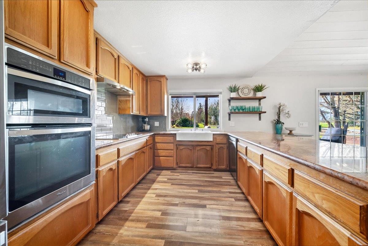 9777 Tavernor Road Wilton, CA 95693 - Photo 14 of 59 a large kitchen with stainless steel appliances granite countertop a lot of counter space and a sink