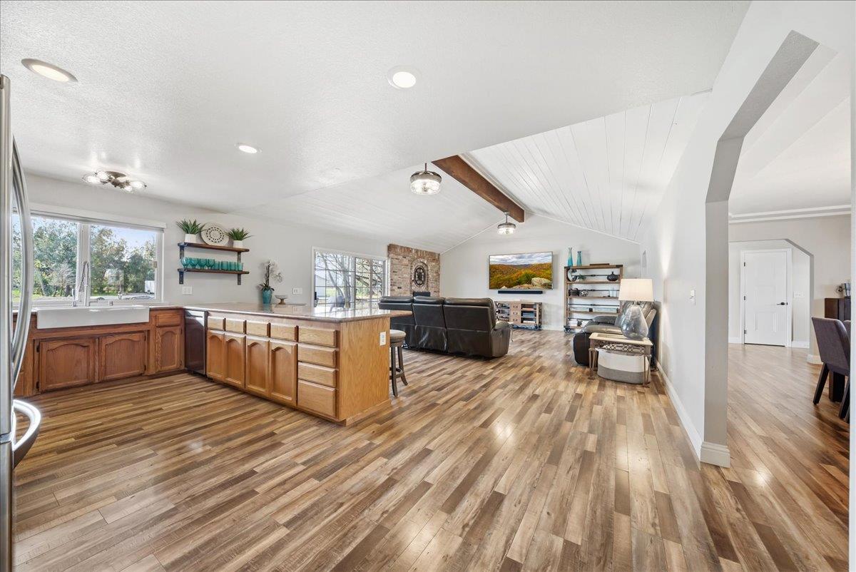 9777 Tavernor Road Wilton, CA 95693 - Photo 15 of 59 a large kitchen with a large counter top a sink stainless steel appliances and windows