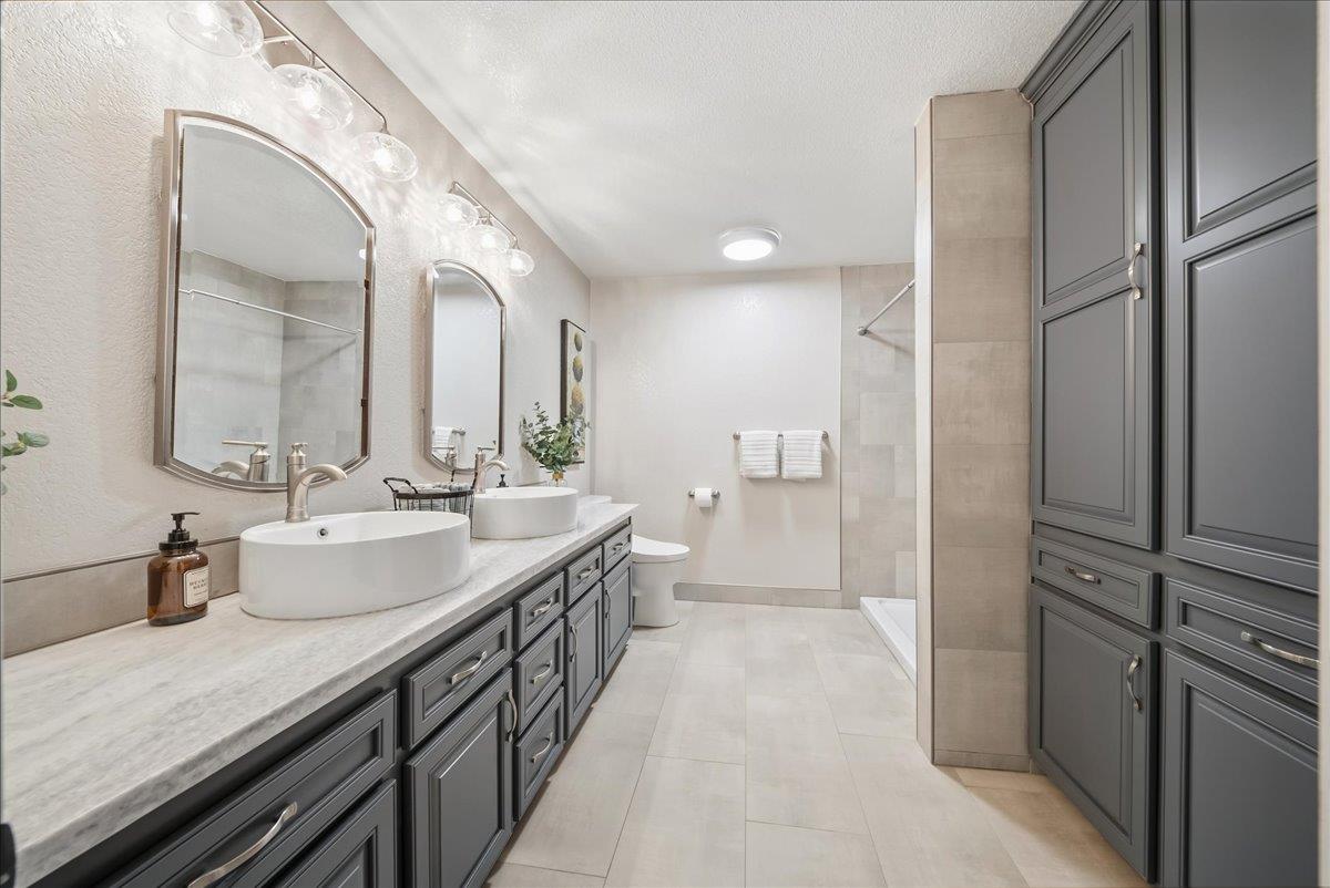 9777 Tavernor Road Wilton, CA 95693 - Photo 18 of 59 a spacious bathroom with a double vanity sink and a mirror