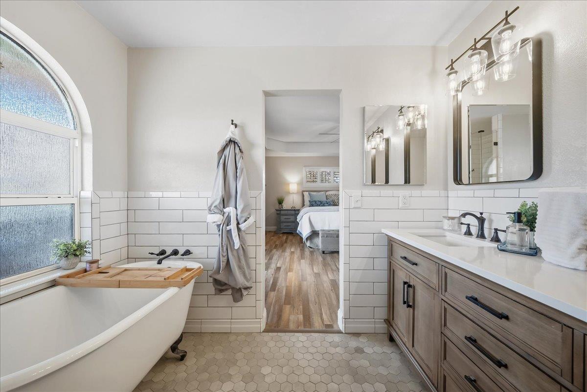 9777 Tavernor Road Wilton, CA 95693 - Photo 26 of 59 a bathroom with a tub sink and mirror