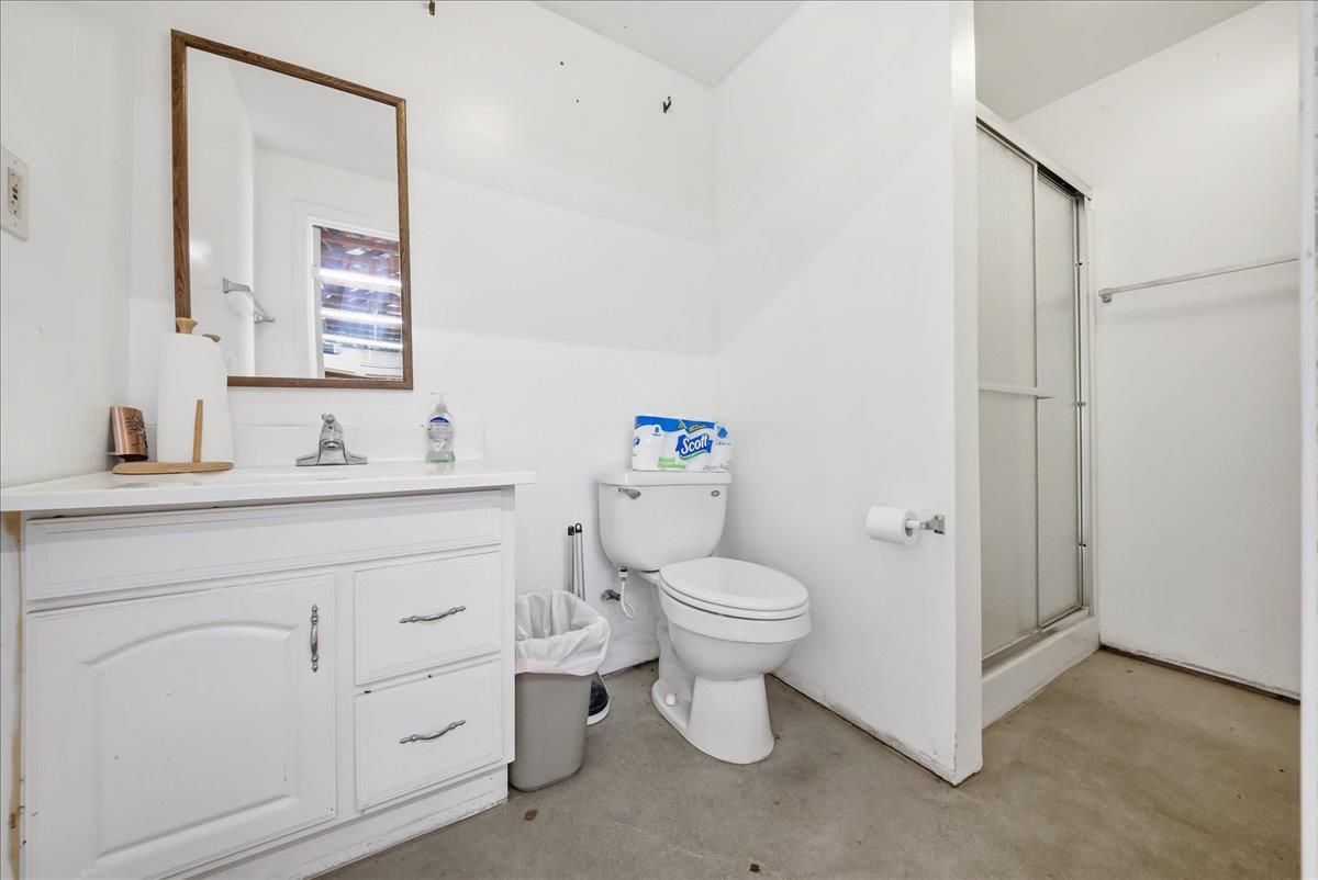 9777 Tavernor Road Wilton, CA 95693 - Photo 46 of 59 a bathroom with a toilet sink vanity and mirror