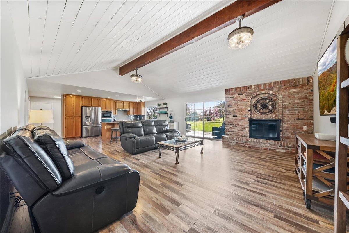9777 Tavernor Road Wilton, CA 95693 - Photo 9 of 59 a living room with furniture a fireplace and a flat screen tv