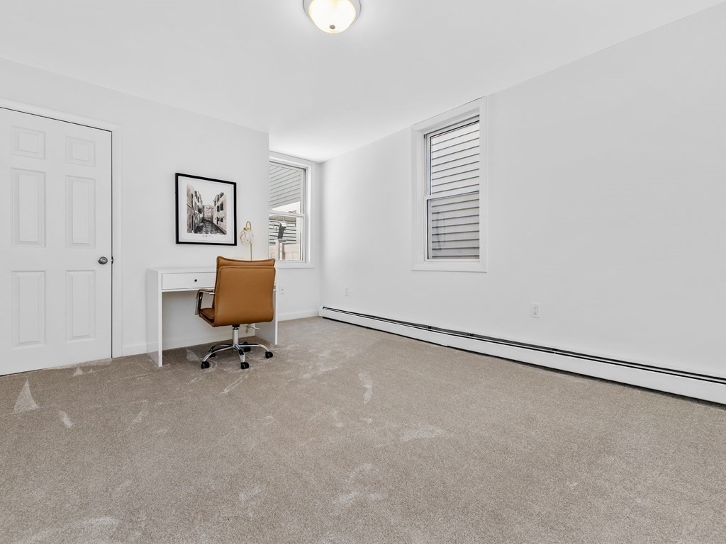 18 R Polk Street Boston, MA 02129 - Photo 9 of 19 a view of workspace with wall painting and a window
