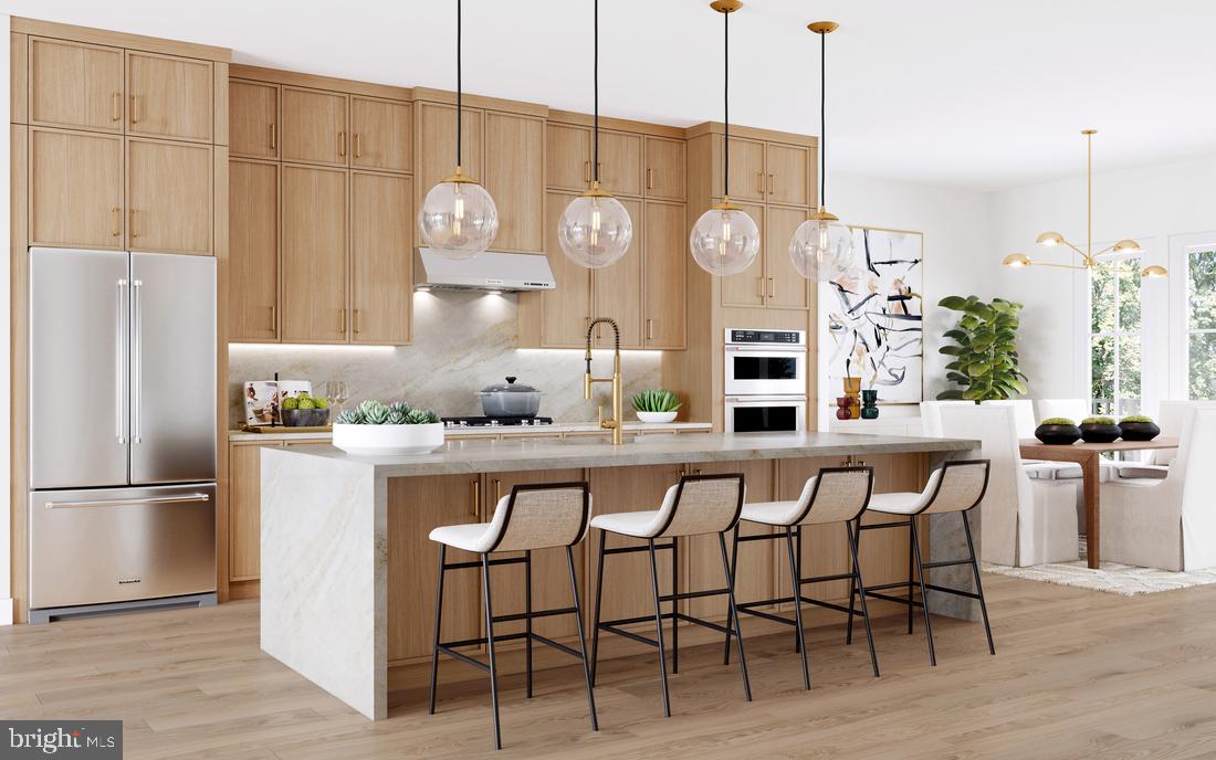 8613 Erdem Place Chevy Chase, MD 20815 - Photo 2 of 7 a kitchen with stainless steel appliances granite countertop a table chairs and wooden floor