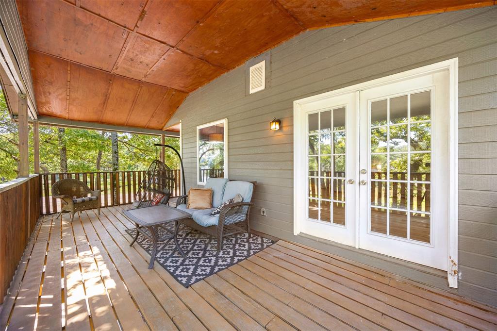 7110 Apache Circle Mabank, TX 75156 - Photo 26 of 39 Expansive covered porch featuring wood flooring, wood-paneled walls, and a wood ceiling