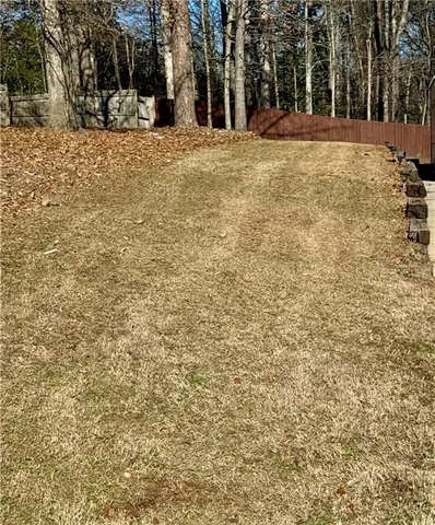 a big yard with trees in front of it