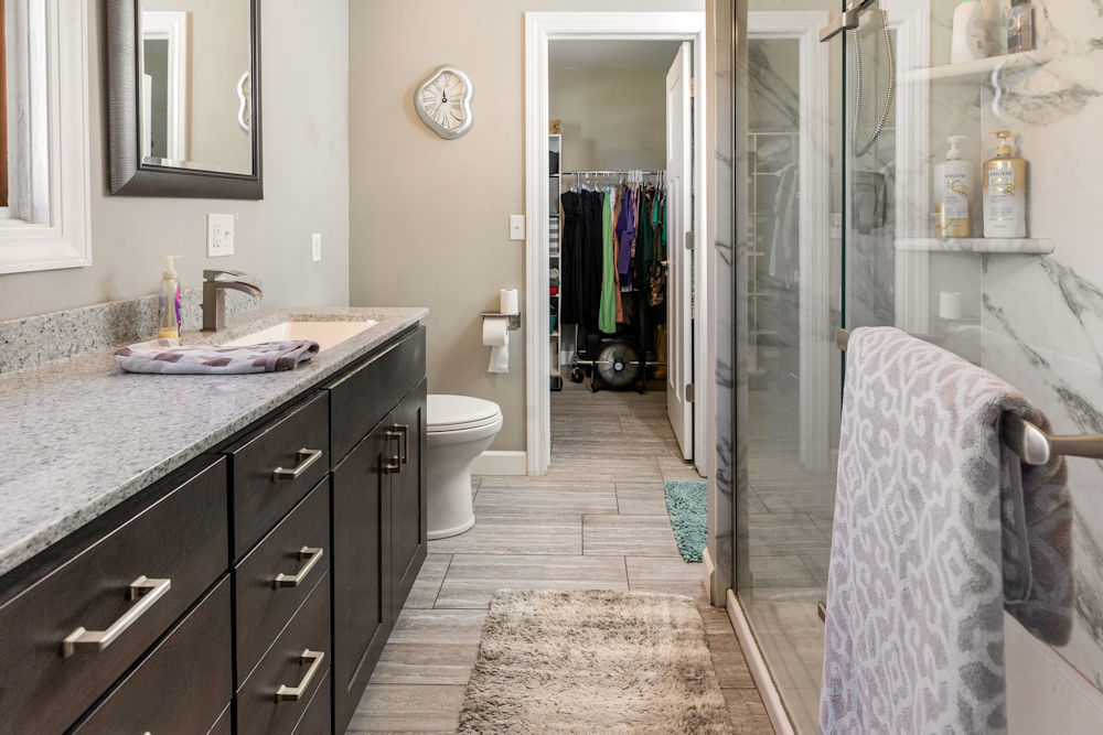 1067 North Main Street Rochelle, IL 61068 - Photo 14 of 18 a spacious bathroom with a granite countertop sink and a mirror