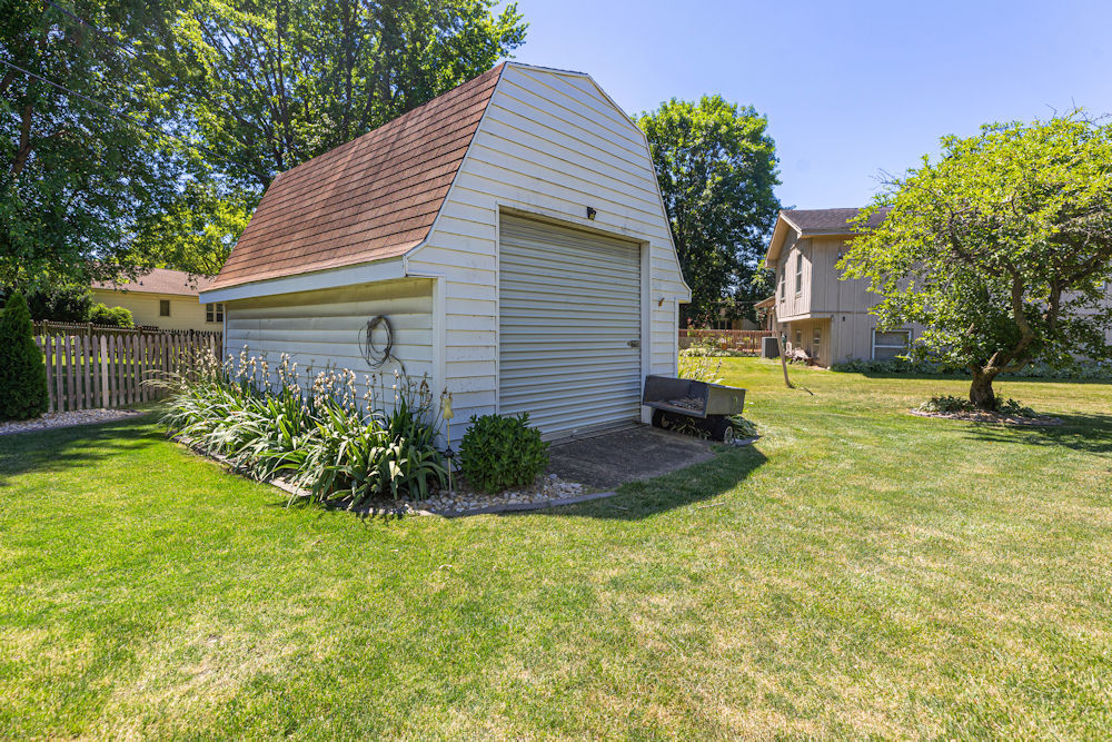 1067 North Main Street Rochelle, IL 61068 - Photo 18 of 18 a view of a house with a yard and a garden