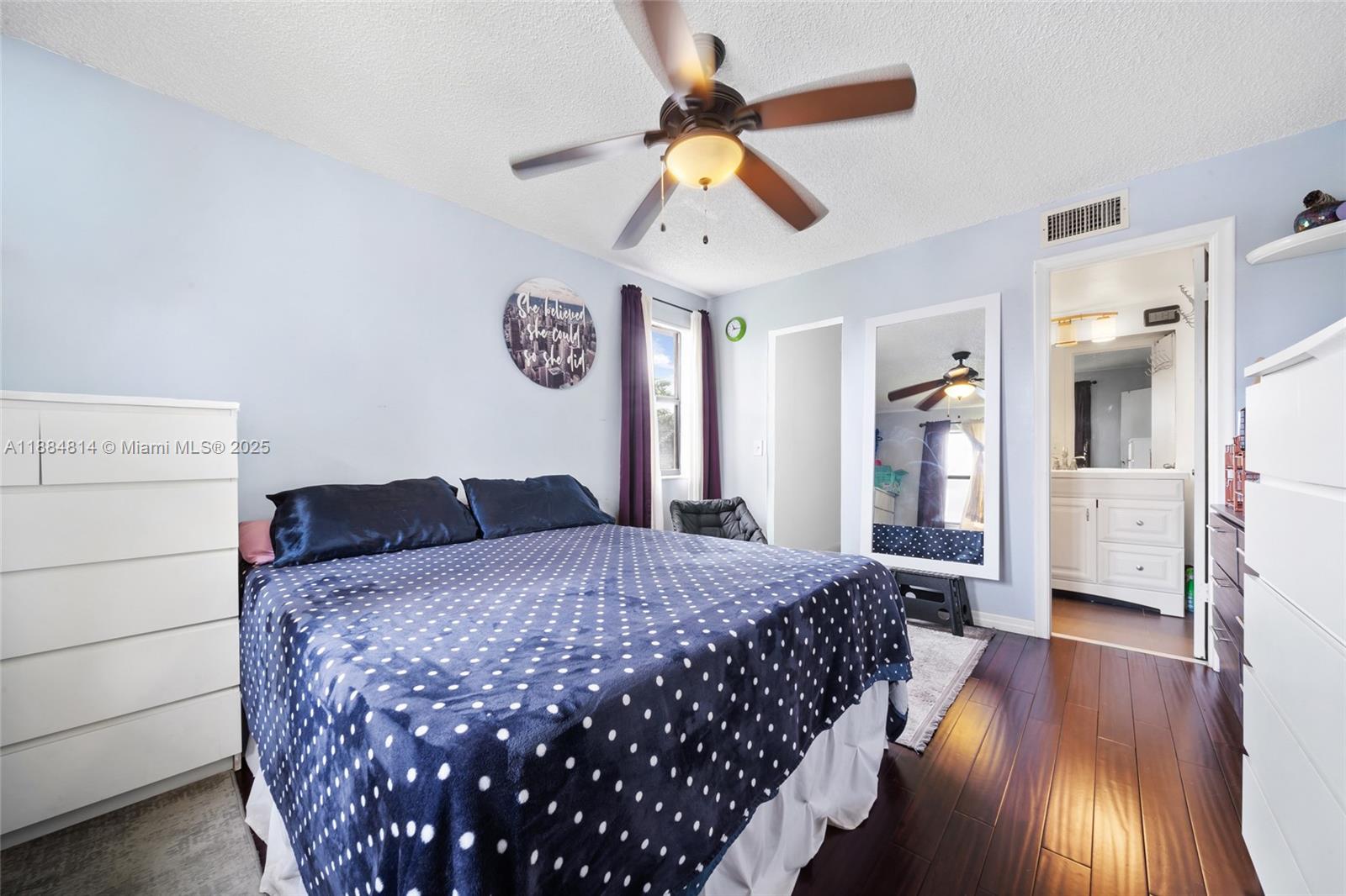 9258 Northwest 1st Street, Unit 206 Pembroke Pines, FL 33024 - Photo 12 of 22 a bedroom with a bed and a chandelier