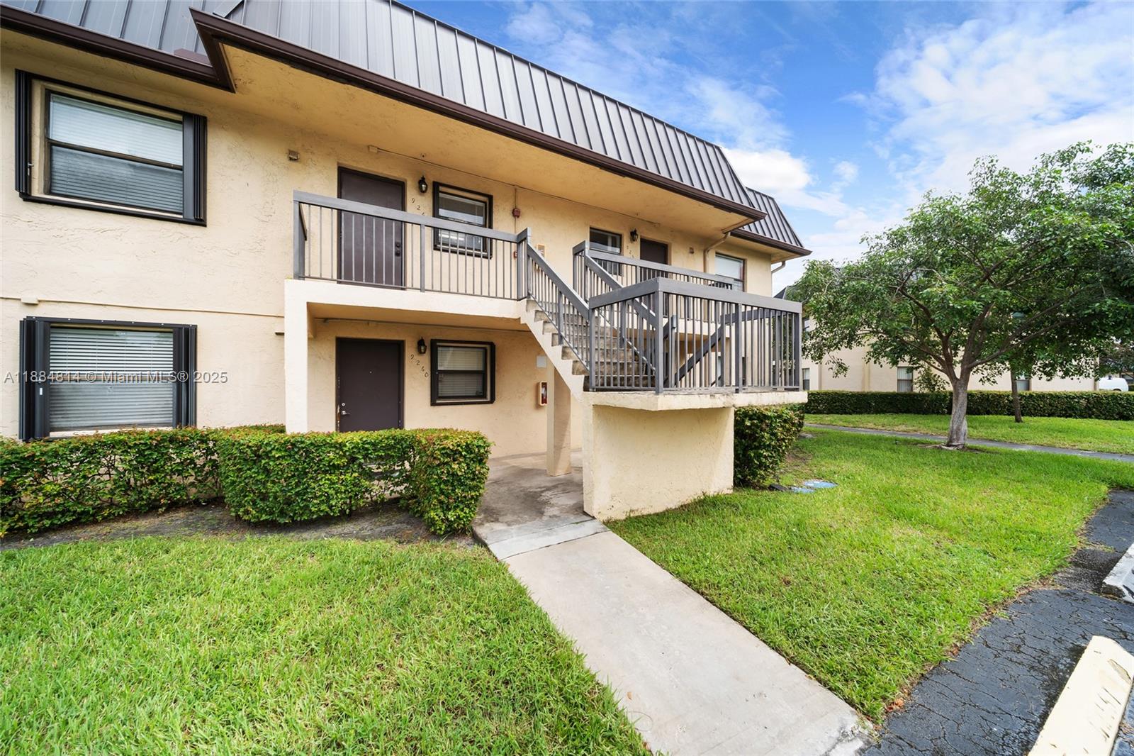 9258 Northwest 1st Street, Unit 206 Pembroke Pines, FL 33024 - Photo 20 of 22 a front view of a house with a yard