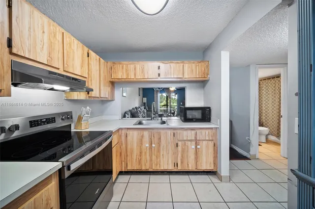 a kitchen with a sink cabinets and appliances