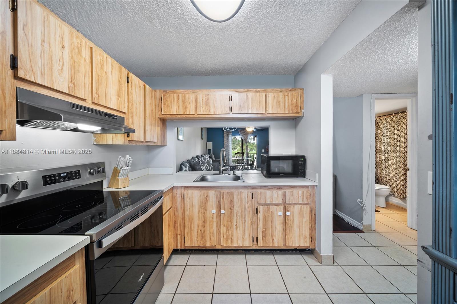 9258 Northwest 1st Street, Unit 206 Pembroke Pines, FL 33024 - Photo 4 of 22 a kitchen with a sink cabinets and appliances