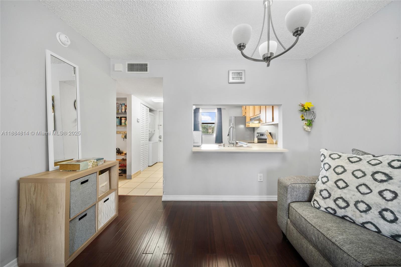9258 Northwest 1st Street, Unit 206 Pembroke Pines, FL 33024 - Photo 6 of 22 a hallway with wooden floor and furniture