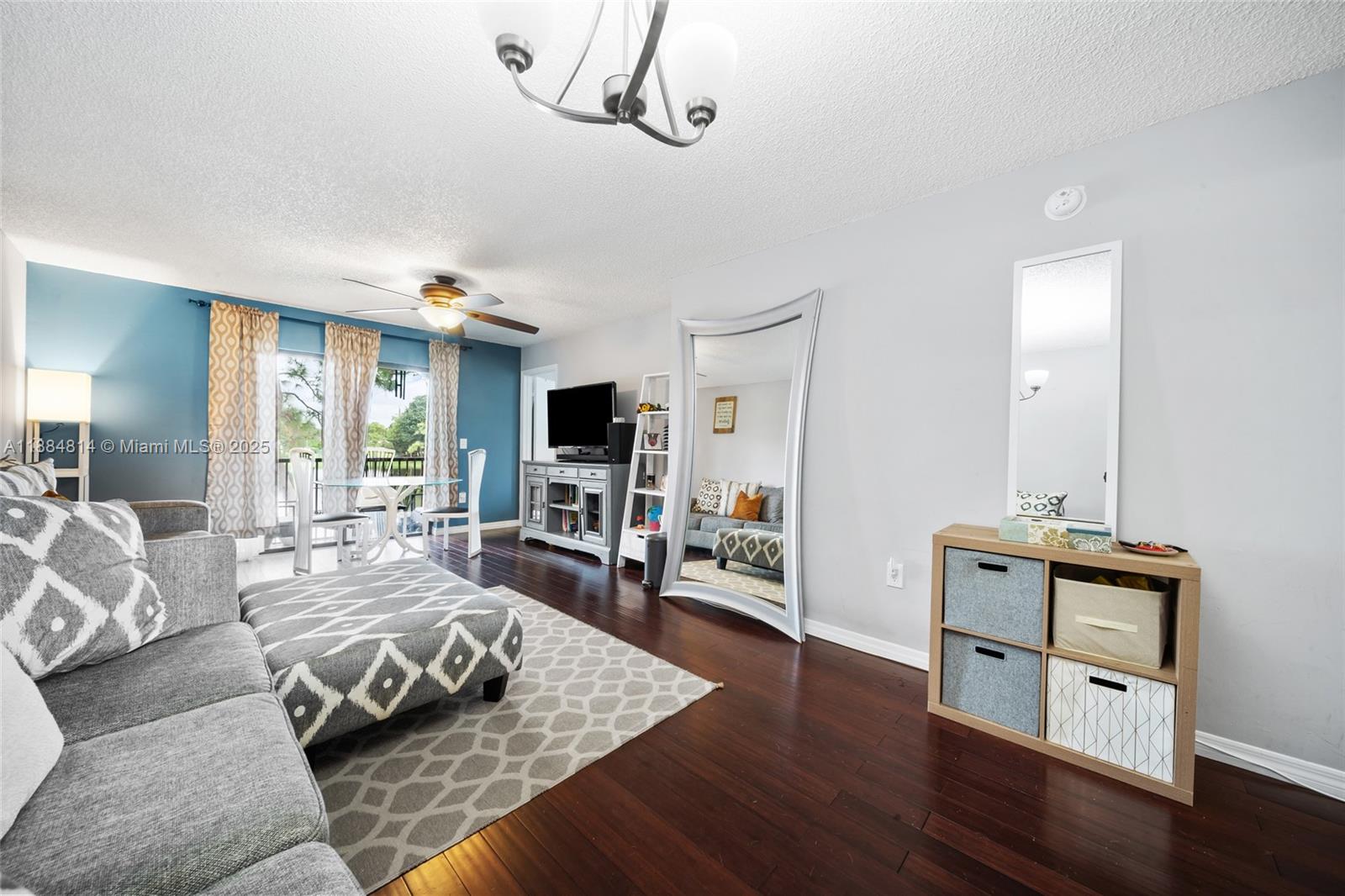 9258 Northwest 1st Street, Unit 206 Pembroke Pines, FL 33024 - Photo 8 of 22 a living room with furniture flat screen tv and wooden floor
