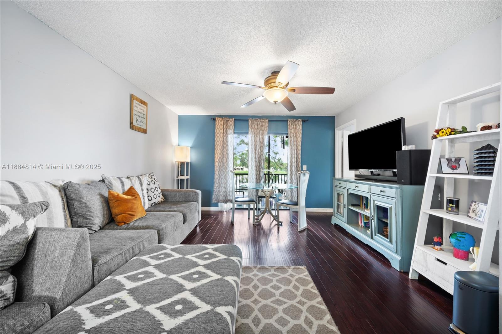 9258 Northwest 1st Street, Unit 206 Pembroke Pines, FL 33024 - Photo 9 of 22 a living room with furniture and a flat screen tv