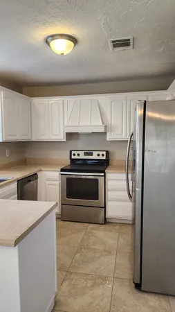 a kitchen with a stove and a refrigerator